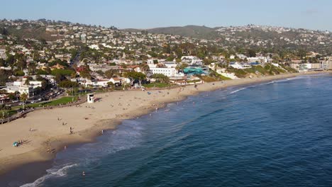 aerial view of people enjoying a sunny day at laguna beach, in california, usa - tracking, drone shot