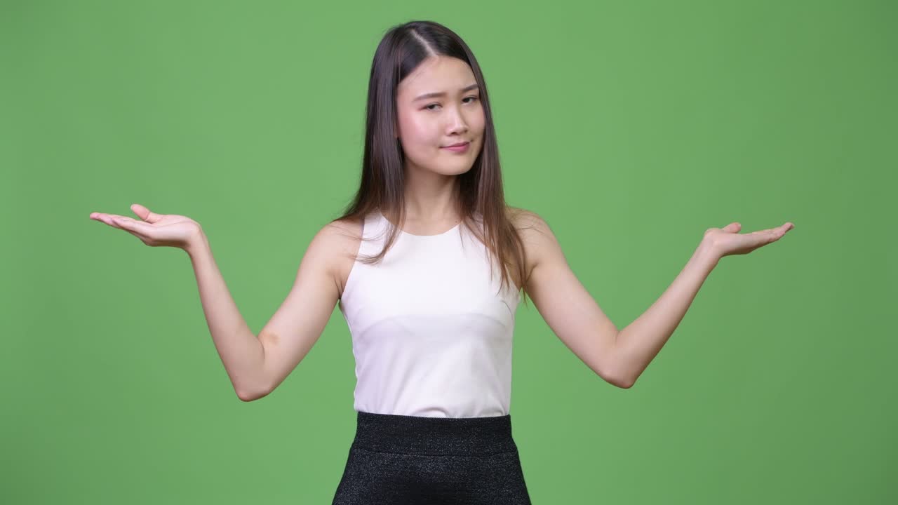 Young beautiful Asian businesswoman choosing between left and right