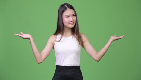 young beautiful asian businesswoman choosing between left and right