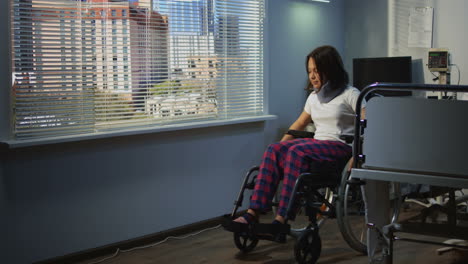 woman in wheelchair in hospital room