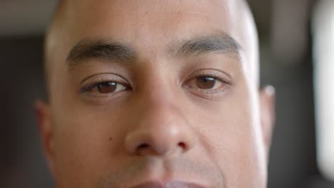 portrait close up of happy biracial man opening eyes and smiling to camera in slow motion