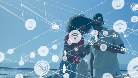 Animation of network of connections with media icons over happy biracial couple