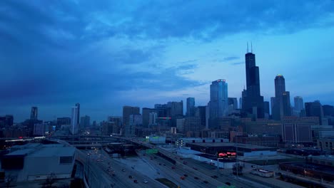 Chicago-Skyline-Cityscape-In-Evening-With-Highway-Traffic-Drone