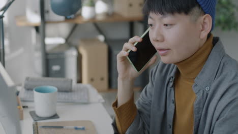 young person on a phone call in modern workspace