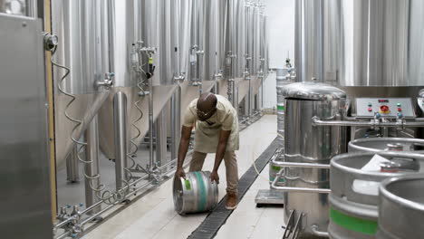 man carrying beer barrel