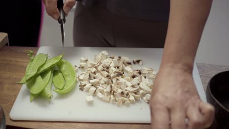 Cropped-shot-of-woman-chopping-mushrooms
