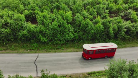 red trolley driving in the road for sightseeing tour in anchorage, alaska