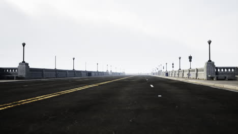 empty bridge roadway in foggy weather