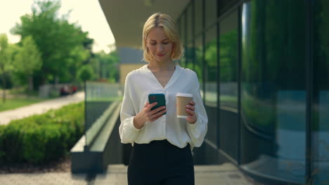 businesswoman walking and using her phone