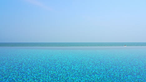 shades of blue on tropical caribbean destination, infinity pool, skyline and sea static full frame