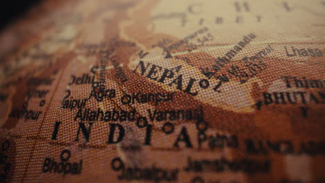 close-up of a world globe focusing on nepal and india