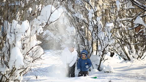 Mother and child in winter day. Mother and son enjoying beautiful winter day outdoors