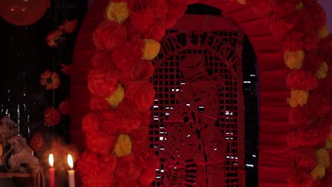 cempasuchil flower wall arch by offerings table, day of the dead