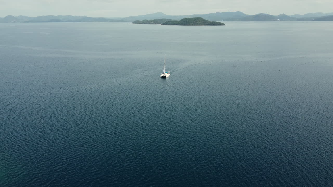 a small yacht in the sea going to an island