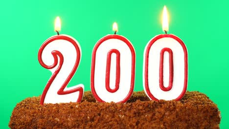 cake with the number 200 lighted candle. chroma key. green screen. isolated