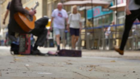 low angle shot of busker on busy street in oxford 01