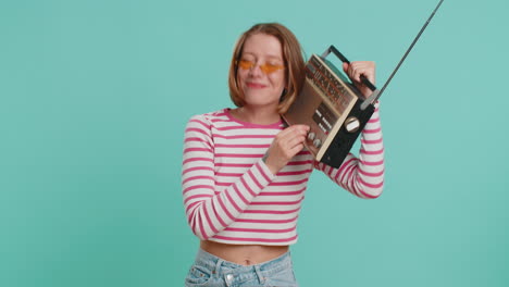 woman using retro tape record player to listen music disco dancing of favorite track having fun