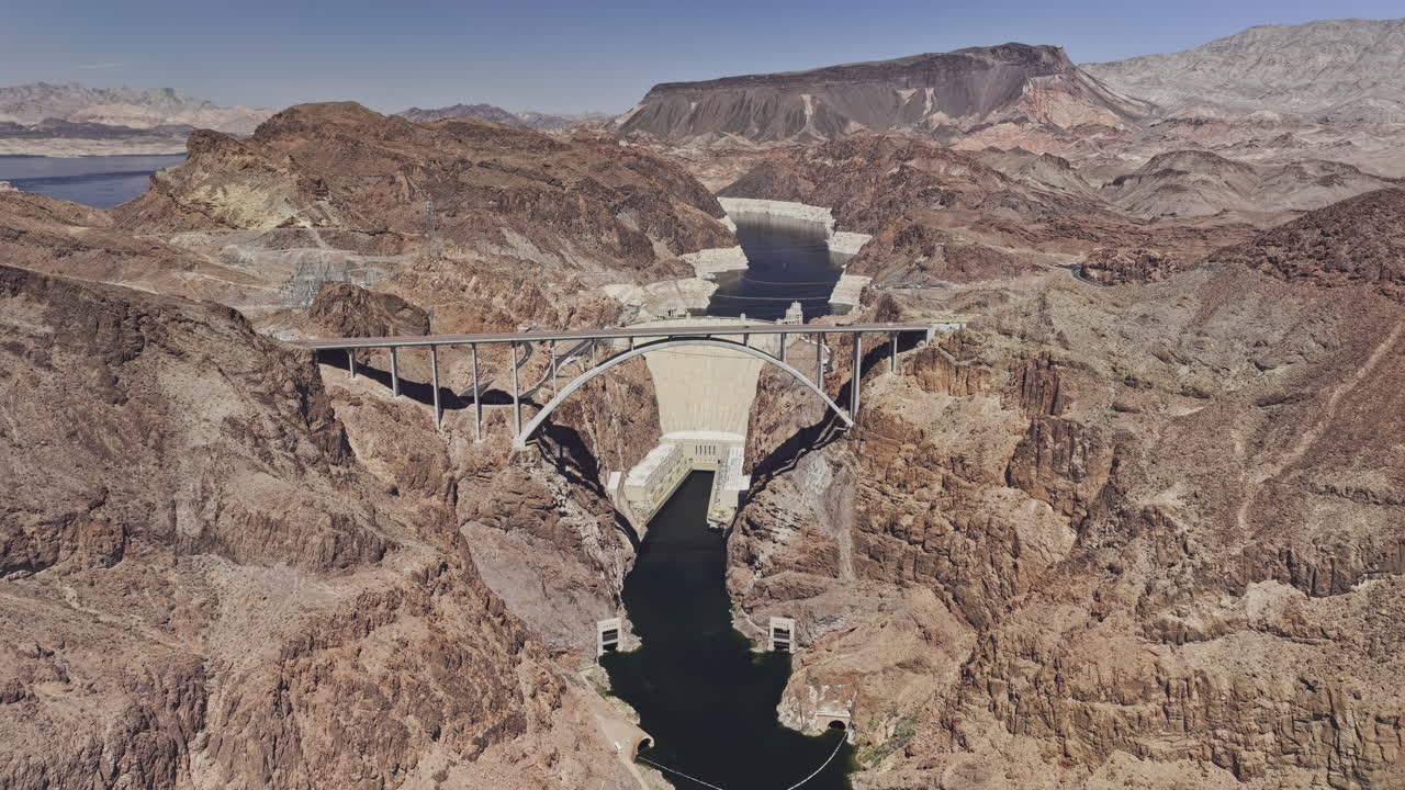 Hoover Dam Nevada Aerial v4 reverse flyover capturing dramatic terrain, winding river canyons, freeway bridge, and views of Lake Mead and mountains - Shot with Mavic 3 Pro Cine - Apr 16th 2024