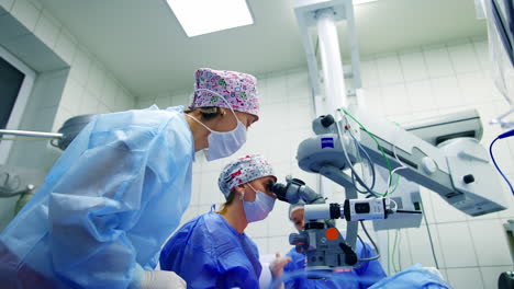 treatment of cataract by surgical method. portarit of eye surgeon at the working plase near the microscope in the operating room