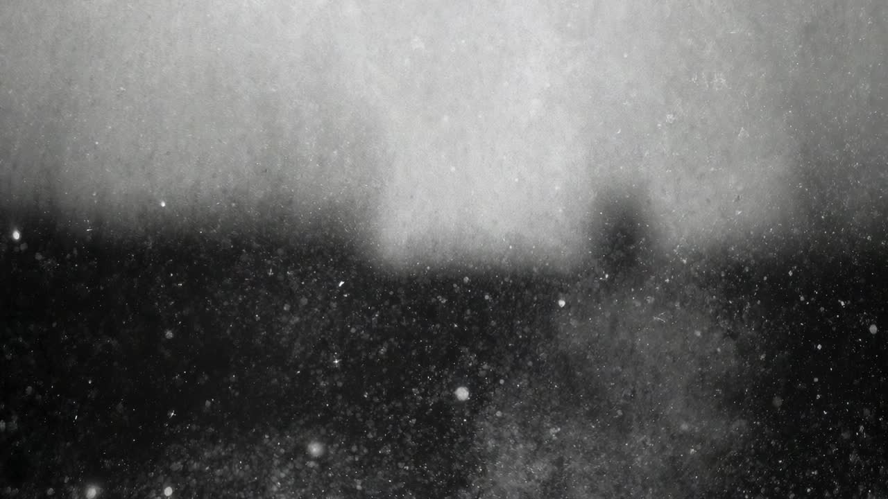 Growing particle field drifting at window forming central plume above dark band showing bright sill