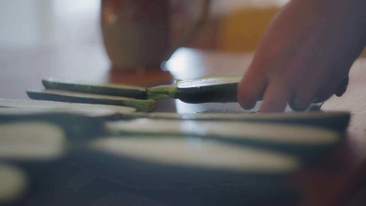 Chef's hands preparing zucchini