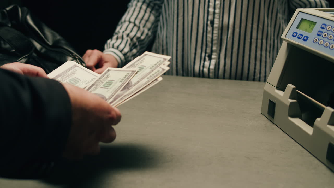 Specialised police officer Counting dollar banknotes in crime lab, conceptual image. High quality 4k footage