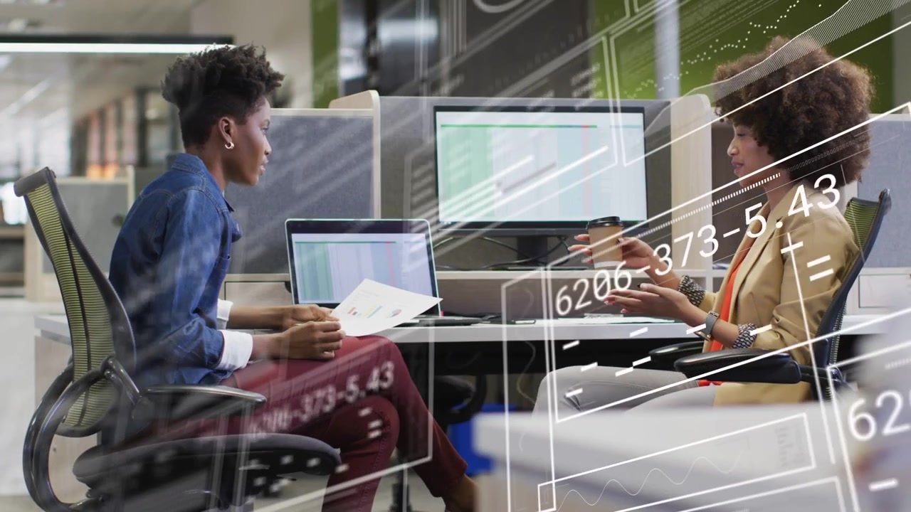 Left colleague holding pages and glancing at laptop, initiating animated charts for business review