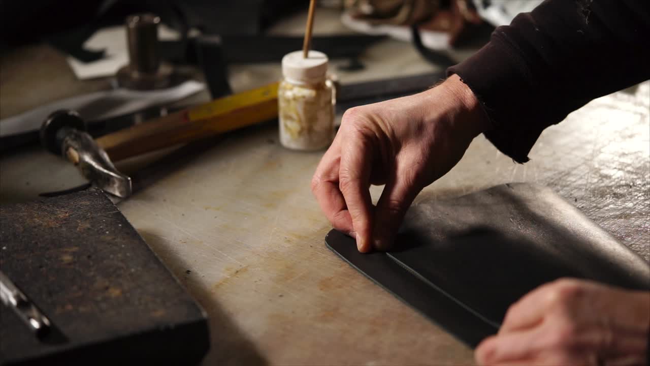 Leather Craftsman Working on Leather Goods