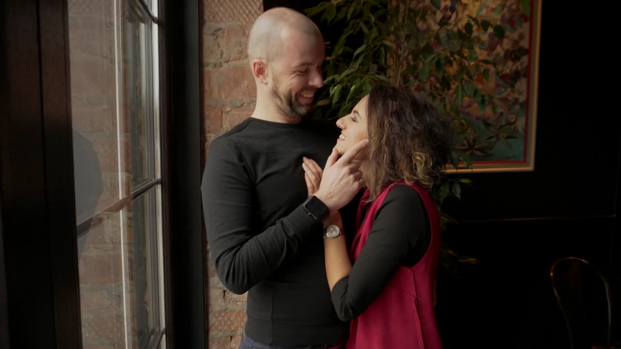 Couple Hugging by the Window