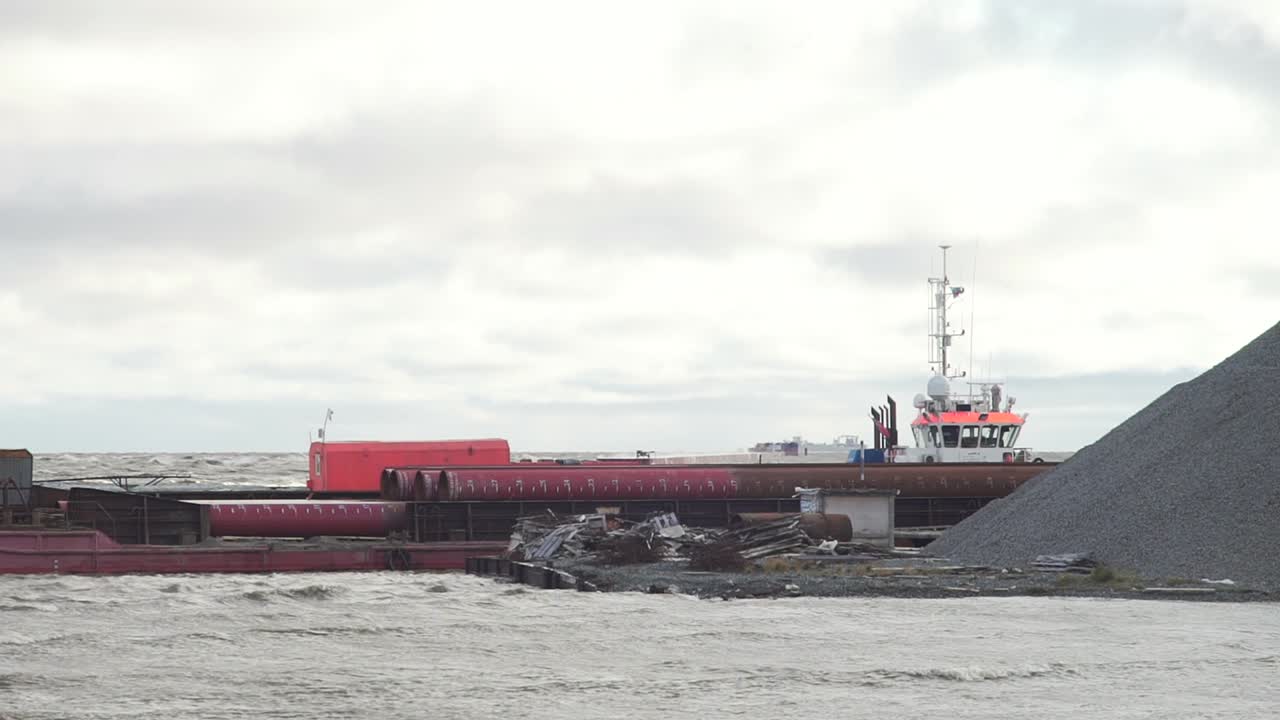 Tugboat and Barge at Port during Loading/Unloading Operations