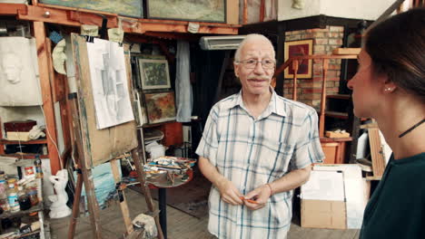 art teacher guiding student in studio