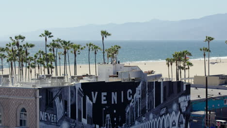 toma de lente larga de la playa de venecia con el edificio y el mural en la parte inferior del marco