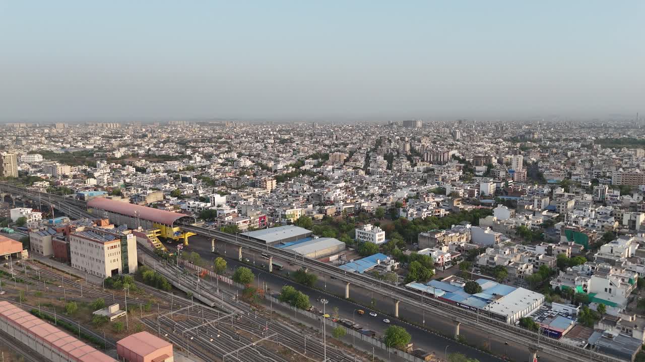 Aerial view of Jaipur city, showcasing dense urban sprawl, wide roads, and iconic pink architecture, reflecting the vibrant energy of Rajasthan
