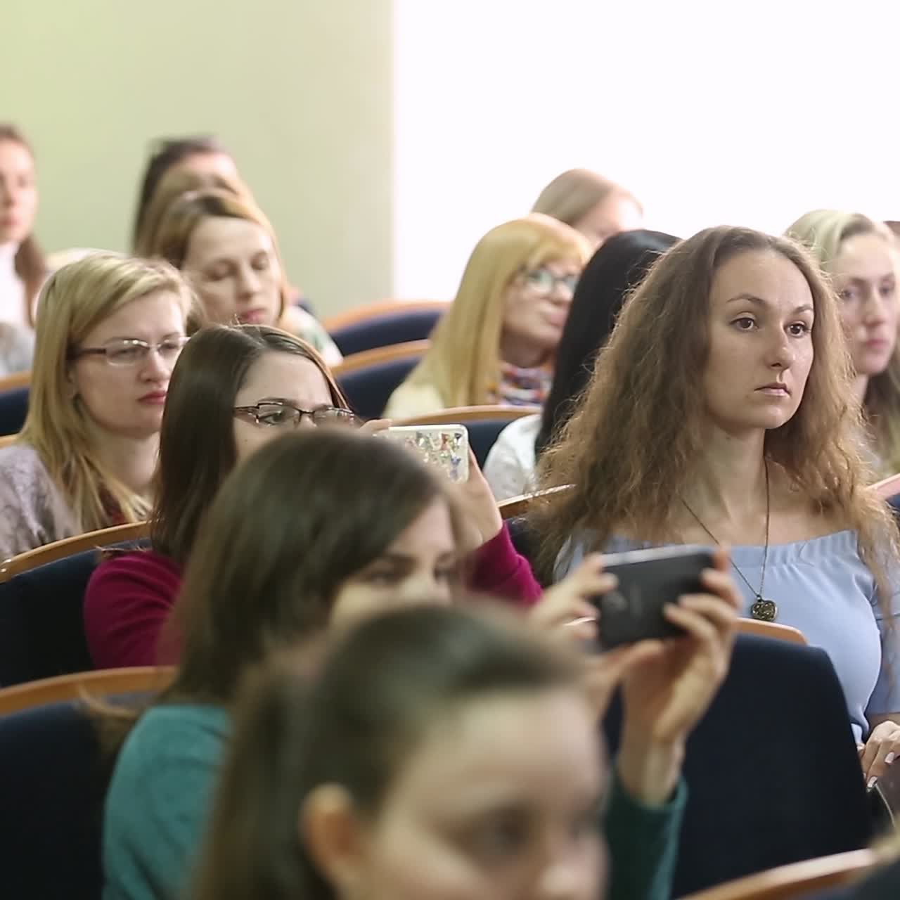 Classmates Sitting In Classroom During Lecture