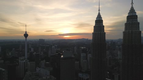 sunset drone fly kuala lumpur capital city of malaysia, twin towers at sunset skyline, famous asian business center
