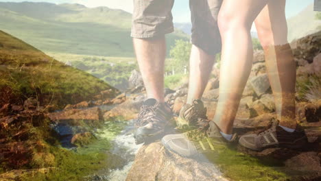 hiking shoes on rocky terrain over scenic mountain landscape