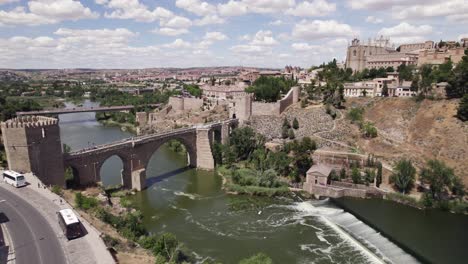 river tagus flowing under puente de san martin bridge