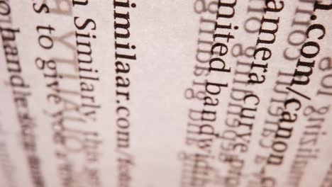 A macro panning of a book´s page with light streaming through it