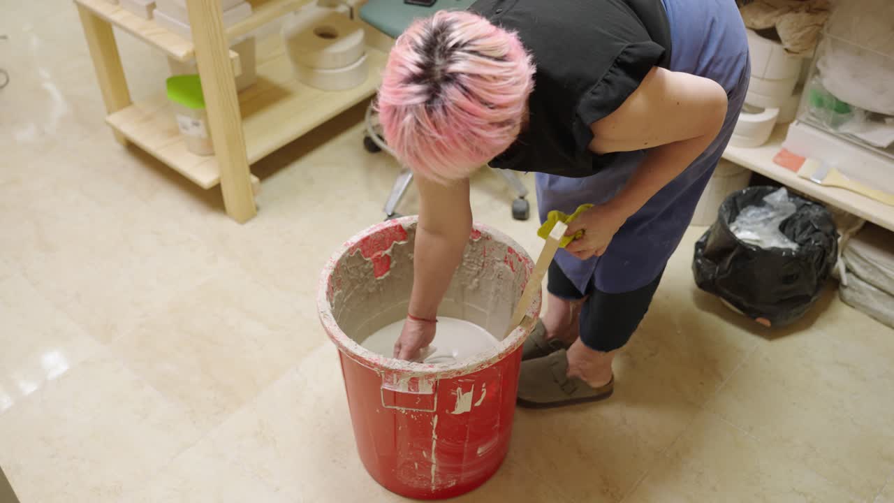 A person making ceramics indoors