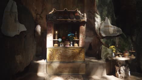 a buddhist altar located inside a cave in marble mountain, da nang, vietnam