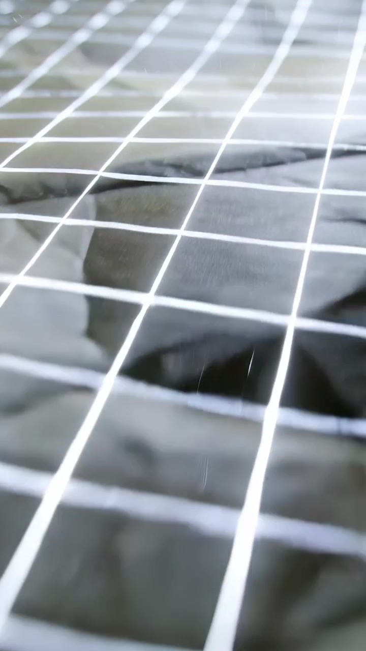 Vertical video: Starting camera moving across table, showing black grid sheet and highlights