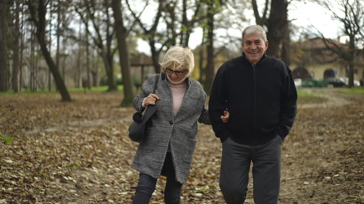 An Elderly Couple Enjoying a Walk in the Park