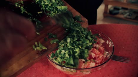 close-up-of-cutting-board-full-of-coriander-to-be-added-to-the-salad