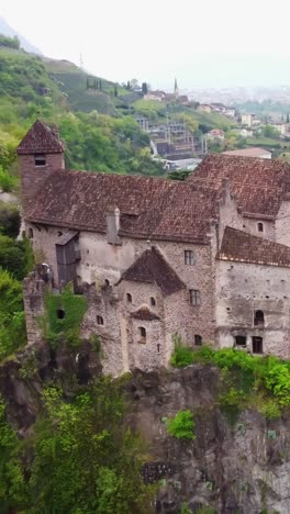 vertical shot of the ancient stone walls of roncolo castle, showcasing the historical architecture and timeless structure.