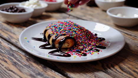 decorating a dessert with chocolate and sprinkles