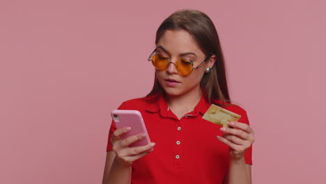 young woman using credit bank card and smartphone while transferring money purchases online shopping