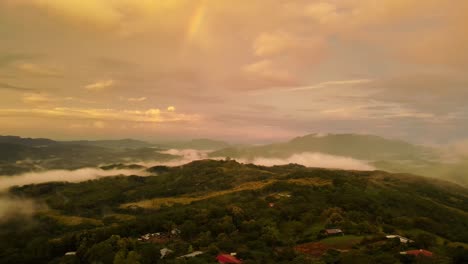 drone view flight over the mist and rainbow in the dense forests of costa rica