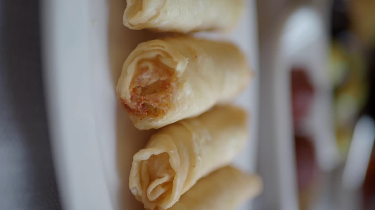Close-up of golden fried spring rolls on a plate