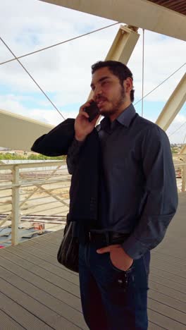 businessman communicating via phone in city setting
