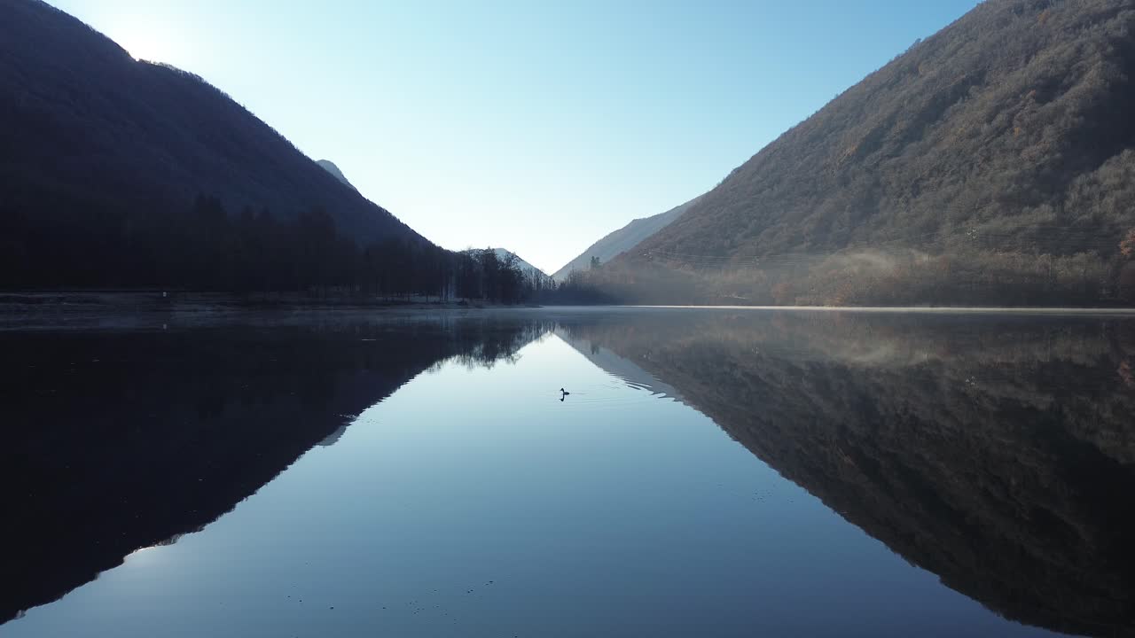 panoramas and cabins that reflect the calm water in a morning where peace peeks through and the sky and water come together. In drone shot